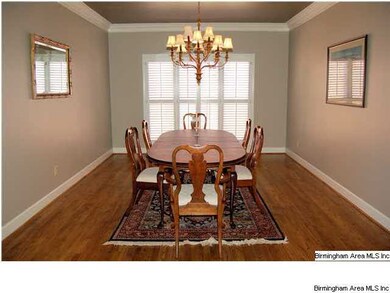 The formal dining room is spacious with high ceili
