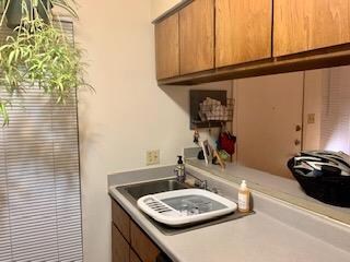 Kitchen featuring light countertops and brown cab