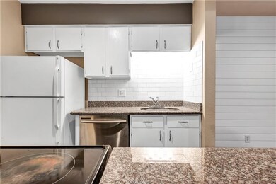 Kitchen with freestanding refrigerator, dishwasher