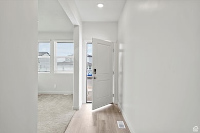 Entrance foyer featuring baseboards and light wood-style flooring