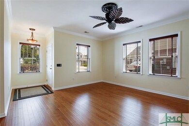 Living Room with Hardwood Floors and Crown Molding