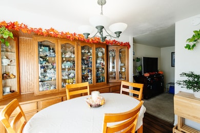 Dining room featuring a chandelier and dark wood-type flooring