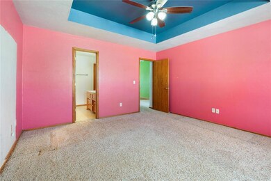 Unfurnished bedroom featuring light carpet, ensuit