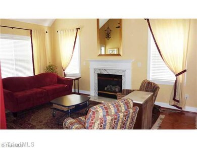 Living Room. Wood floors in living and dining areas and convenient to the kitchen. Tall cathedral ceiling gives a more open atmosphere.