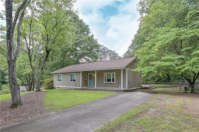 Ranch-style home with a porch, driveway, board and