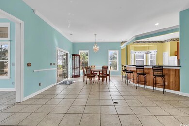 Dining space with light tile patterned floors, bas