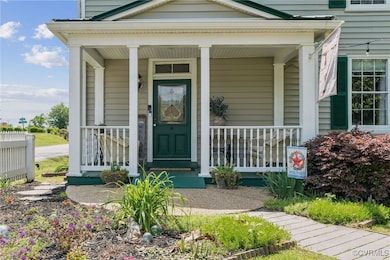 View of main entry featuring a porch