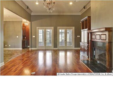 Another view of the living room looking towards the screen porch and backyard. The bar is the the left, as are the kitchen, dining room, 4th bedroom and full bath.