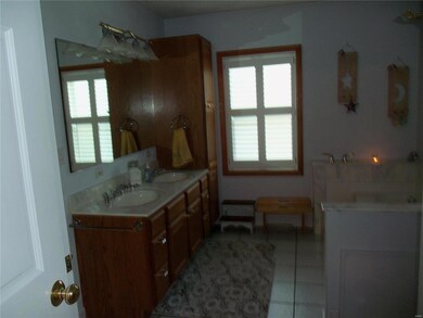 Huge master bath has double sinks, jetted tub and separate shower.