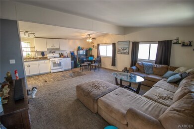 Open concept living room/kitchen with carpeted liv