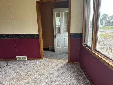 Carpeted empty room with baseboards and stone finish flooring