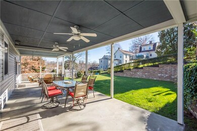 Patio Walk out from The Dining Rm. Lighting and 2 Fans. Beautiful Landscaping. Huge retaining wall.