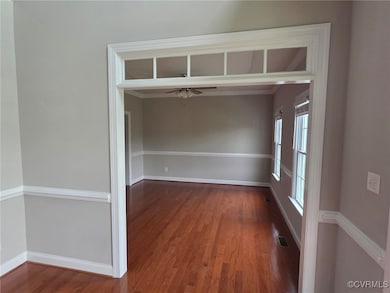 Unfurnished room with baseboards, visible vents, a