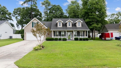 Cape cod house featuring a porch, a garage, centra