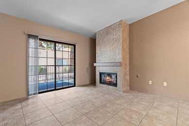 Unfurnished living room featuring a tile fireplace