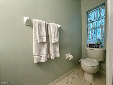 Bathroom with tile patterned flooring and toilet