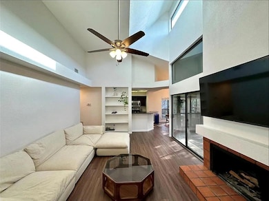 Living area featuring a high ceiling, ceiling fan
