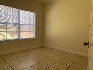 Empty room with baseboards, ornamental molding, a