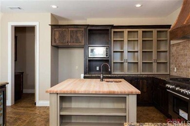 Butcher block counter top on island.  Glass front 