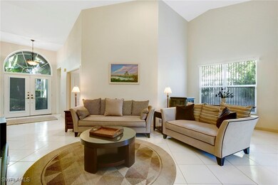 Living area featuring high vaulted ceiling, tile f