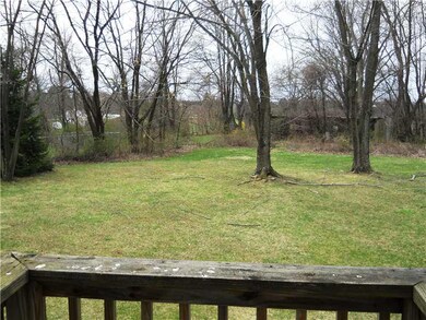 Exterior Back. Level rear yard that backs to treed