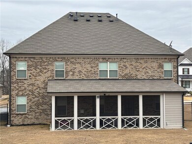 Rear view of house with brick siding and a shingled roof