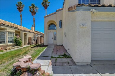 Property entrance with stucco siding, a garage, an