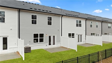 Back of property featuring a patio, central AC unit, a yard, and french doors