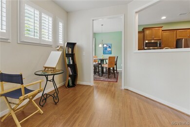 Sitting room with light wood finished floors, base