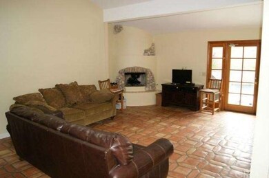 Large Family Room with fireplace and doors leading to the pool area
