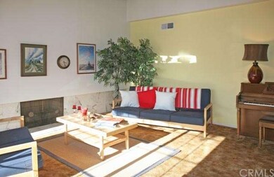 Formal living room has marble fireplace