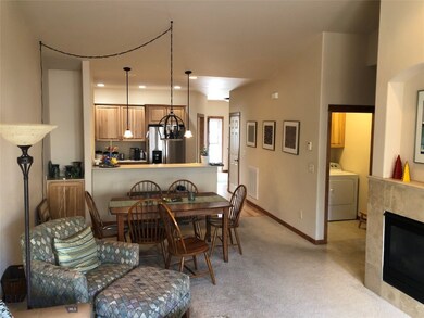 Carpeted dining space featuring a tile fireplace,
