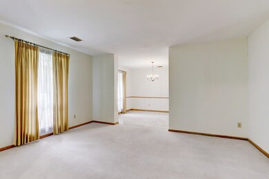 To the left of foyer is a spacious front living ar