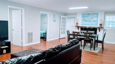 Living area with wood finished floors and baseboards