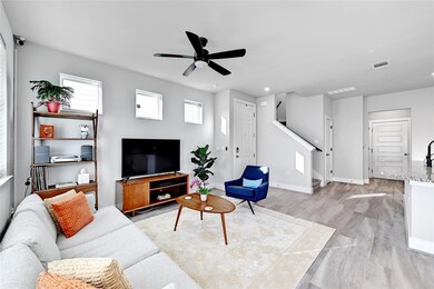 Living room featuring visible vents, stairway, li