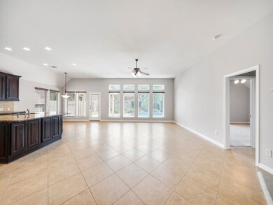 Exquisite, light and bright open concept main living area! This great room is the perfect set up for entertaining with ample space and ample windows to view the backyard oasis!