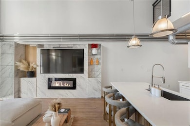 Custom storage and entertainment built-in adds style and sophistication to the space. While the fireplace adds drama to evenings in front of the TV.