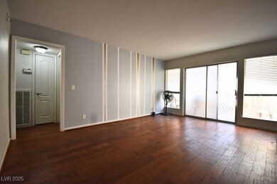 Empty room featuring wood finished floors and base