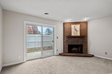 Unfurnished living room with carpet floors, brick 