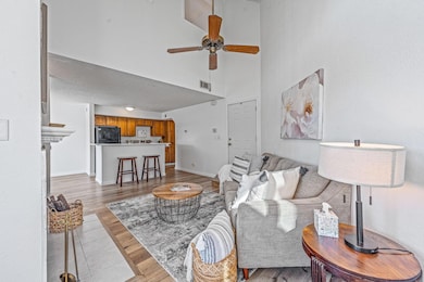 Living room with ceiling fan, light Luxury Vinyl f