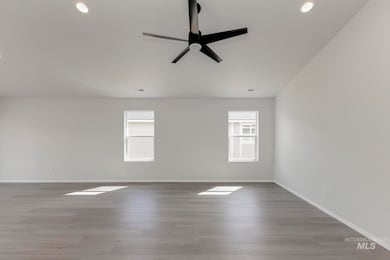 Empty room with light wood finished floors, ceiling fan, and recessed lighting