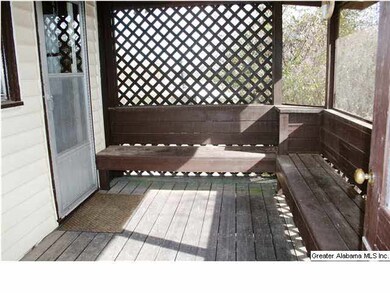 SCREENED DECK HAS BUILT-IN SITTING.