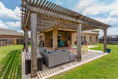 This stunning wood pergola adds charm to the Back Porch and is ideal for enjoying the outdoors without the harsh glare of direct sunlight. Notice the extended back patio, ideal for grilling or a fire pit.