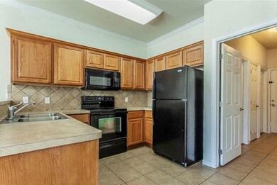 Kitchen with a sink, light tile patterned flooring