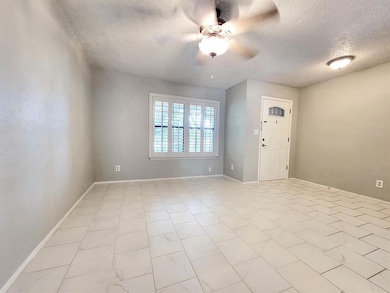 Entryway featuring a textured ceiling and a ceiling fan