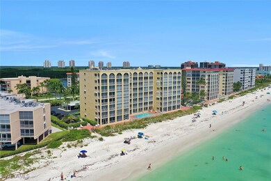 View of property with a view of the beach and a wa