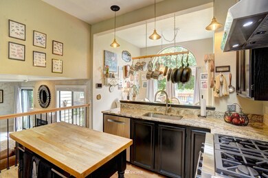 Chef's kitchen complete with SS Appliances, dual-burner Wolf oven, granite countertops, pot filler, and more