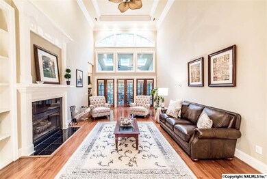 You'll love the soaring ceilings in this true 'great' room featuring cozy fire place, built-ins, hardwood flooring, crown moulding, and three sets of french doors leading to screened-in porch for morning coffee or evening dinners.