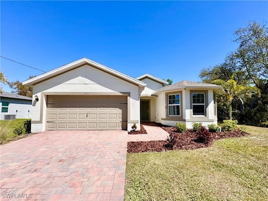 Ranch-style home featuring stucco siding, an attac