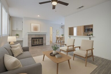 Living area with light wood-type flooring, ceilin
